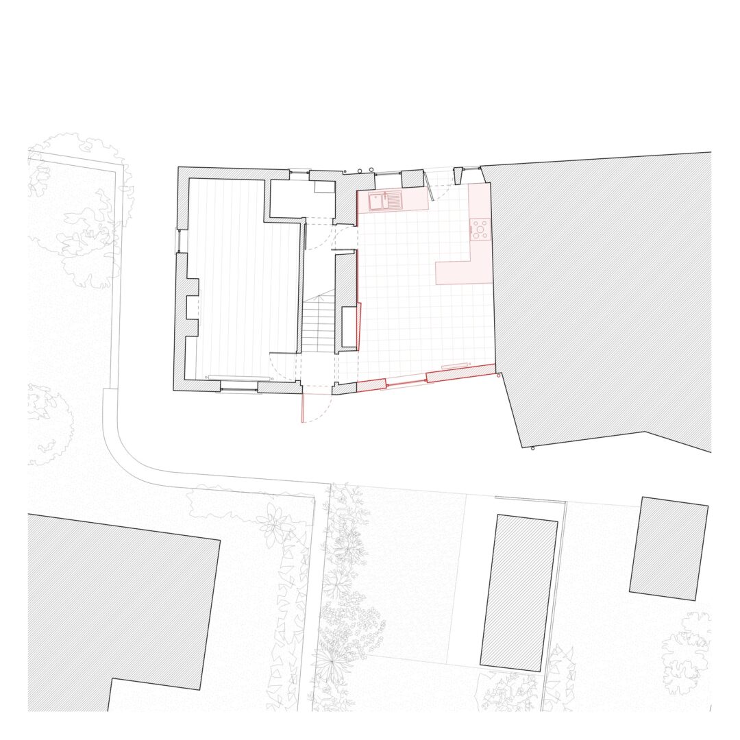 Floor plan showing a building layout with various rooms and furniture arrangements. The plan features areas marked in different shades, possibly indicating different zones or materials. Surrounding landscape includes pathways and vegetation.
