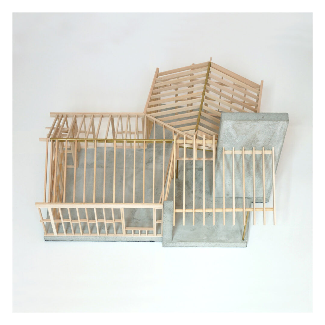 An architectural structural model made of wooden slats with a cast concrete base, arranged in a geometric design. The wooden slats form open frameworks suggesting intersecting planes and angles.