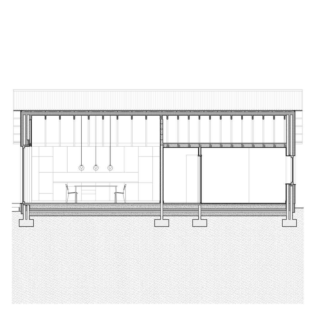 Cross-section architectural drawing of a modern building, showcasing interior elements like pendant lights, a table with two chairs, and large windows. The structure includes visible beams and columns on a textured base.